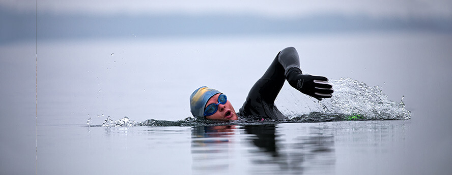 Person swimming in cold water sea