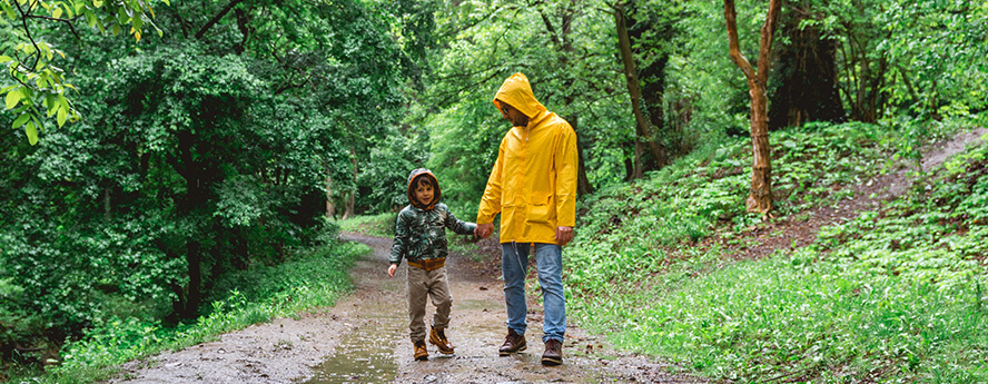 Man walking with his son in the woods