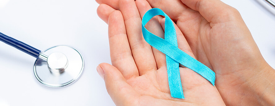 Blue Cervical Cancer Ribbon In Women's Hands Next To Medical Stethoscope